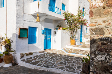 Typical Greek white house and street with flowers in Plaka village, Milos island, Cyclades, Greece