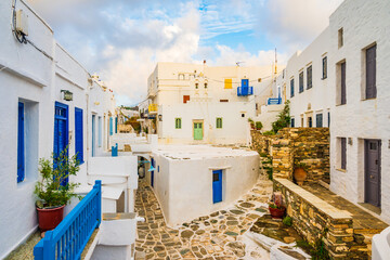 Narrow streets of Kastro village with traditional architecture at sunrise time on Sifnos island,...