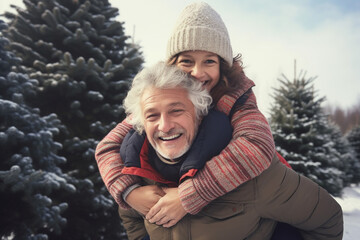 Obraz premium happy smiling grandfather and child with snow in forest