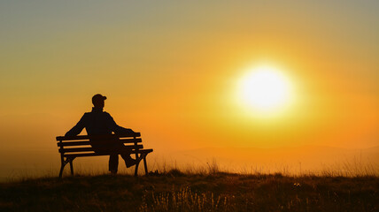 Silhouette of a Man Watching the Sun
