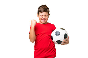Little caucasian kid over isolated chroma key background with soccer ball celebrating a victory