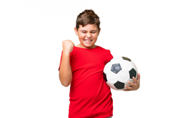Little caucasian kid over isolated chroma key background with soccer ball celebrating a victory