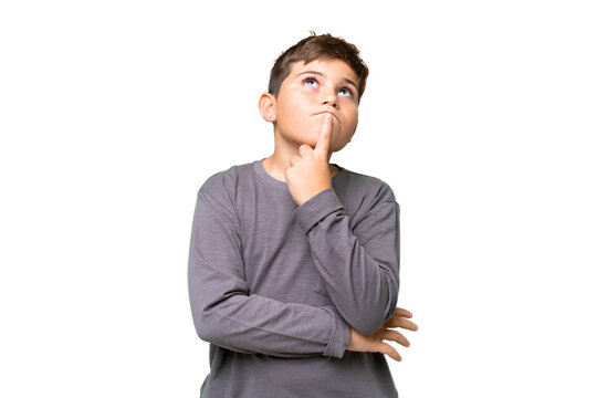 Little caucasian kid over isolated chroma key background having doubts while looking up