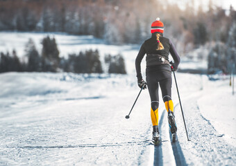 Young woman practices cross-country skiing