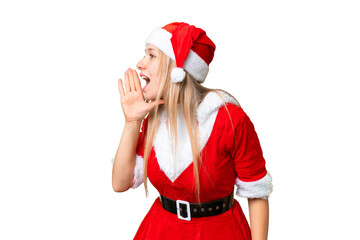 Young blonde woman with christmas hat over isolated chroma key background shouting with mouth wide open to the side