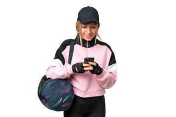 Pretty sport woman with sport bag over isolated chroma key background sending a message with the mobile