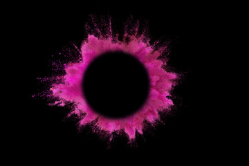 Explosion of colored pink powder with empty space circle for text, isolated on black background