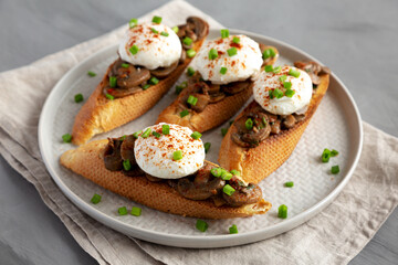 Homemade Creamy Mushroom Toasts on a Plate, side view.