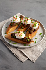 Homemade Creamy Mushroom Toasts on a Plate, side view.