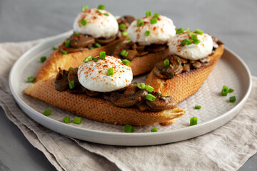 Homemade Creamy Mushroom Toasts on a Plate, low angle view.