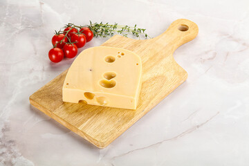 Maasdam cheese brick over board