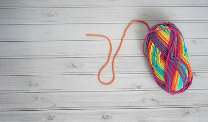 Art and crafts background. Colourful wool for crafting on a white wooden background. Wool tool crafts background space for writing.