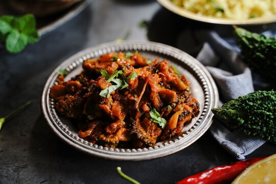 Bitter gourd curry - karela subji served with rice and roti, selective focus