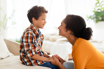 Joyful mother and son engaging in chat talking at home - obrazy, fototapety, plakaty
