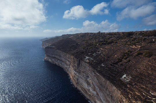 Aerial view of beautiful high cliffs along the coastline facing the Mediterranean Sea, Dingli, Malta.