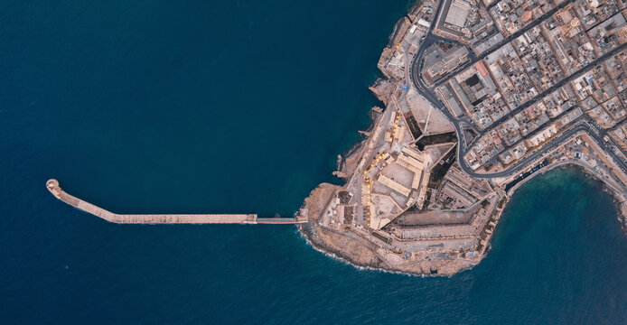Aerial view of Saint Elmo breakwater and Fort Saint Elmo at the point of La Valletta downtown at sunset in Malta.
