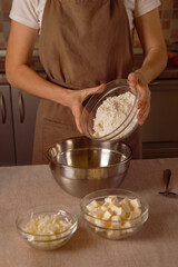 woman chef hands adds flour to make dough for homemade pizza, pasta or baking at home