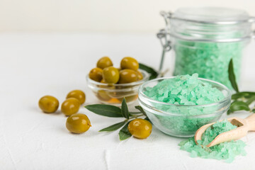 Spa sea salt on the test table. Sea salt with olive extract on the table. Beauty concept. Sea bath salt. Space for text, space for copy. Close-up.