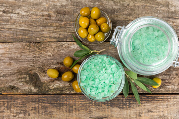 Spa sea salt on the test table. Sea salt with olive extract on the table. Beauty concept. Sea bath salt. Space for text, space for copy. Close-up.
