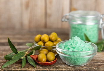 Spa sea salt on the test table. Sea salt with olive extract on the table. Beauty concept. Sea bath salt. Space for text, space for copy. Close-up.