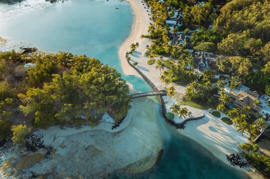 Flacq, Mauritius - 11 October 2022: Aerial view of a luxury resort beachfront along the coastline connecting with a bridge to the island in Ilot Lievres, Flacq, Mauritius.