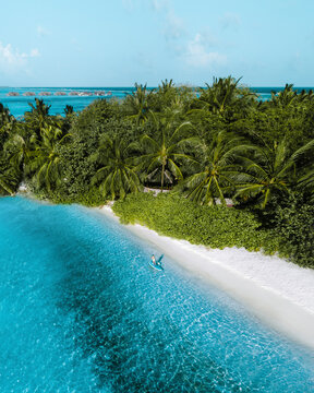 Aerial view of a woman with a canoe along the shoreline, Lankanfinolhu, Maldives.