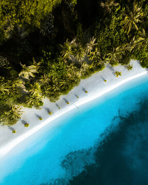 Aerial view of a person along the shore on a paradise beach at Lankanfinolhu, Maldives.