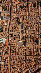 Aerial zenithal view of the historic center of Reggio Emilia, Italy. The orange color of traditional roofs predominates.