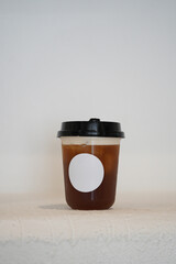 Iced tea drink or iced americano in a plastic cup mock-up on a white background.                   ...