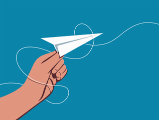 Hand holding and launching a paper airplane