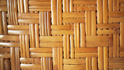 Brown background of woven bamboo. Brown color backgrounds. Abstract background of woven wood texture from bamboo. Wall of traditional old hut house. Pattern of brown woven wall texture background.