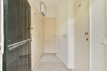 an empty hallway with no people or objects on the wall and door to the left, there is only one person in the room