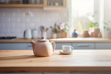 Fotobehang Imagen de una encimera de cocina con una tetera y una taza. © ACG Visual