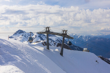 Funicular cableway to ski resort Rosa Khutor in Krasnaya Polyana at Sochi, Russia against snowy...
