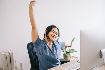Happy businesswoman warming up body and stretch her arms at workplace, feeling satisfied with work...