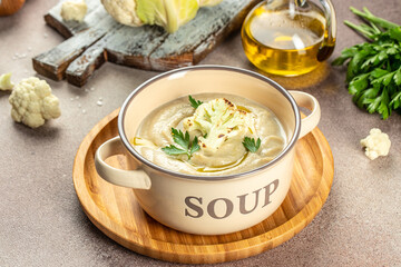 Vegetarian white soup cream from cauliflower on a light background top view. place for text