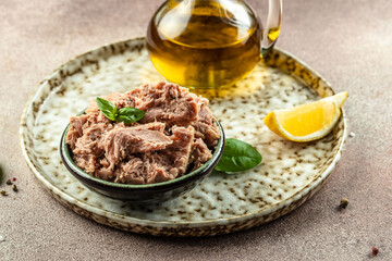 Canned tuna steak in brine on a light background. Restaurant menu, dieting, cookbook recipe top view