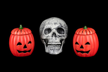 Halloween pumpkin Jack o' Lantern and human skull decorate for halloween seasonal isolated on black background. (This is toy model)