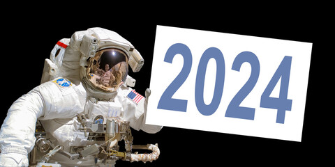 Astronaut in space holding a 2024 white  board - elements of this image are provided by NASA