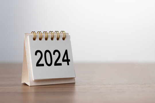 2024 Happy New year background. Turns over a calendar sheet. Setup objective target business cost and budget planning of new year concept. year change from 2023 to 2024..