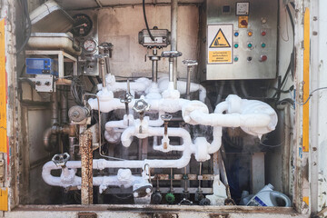 Control panel of liquid nitrogen process pipeline with iced exposured on the pipeline due to the extra low temperature. Industrial equipment and process device object, selective focus.