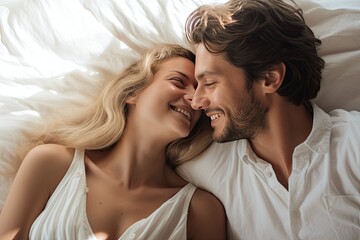 Fototapeta na wymiar lovely caucasian couple on bed peacefully sleeping looking at each other and smiling