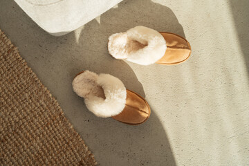 Top view on home cozy slippers. Home footwear on the floor 