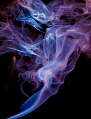 Fototapeta premium Vibrant color incense smoke on black
