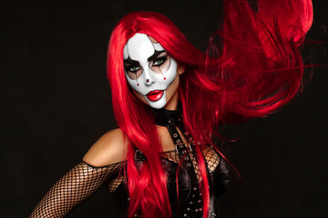 Sexy woman in a Halloween makeup on black background.