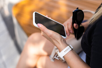phone in the hands of a girl and a smart watch on her hand mockup