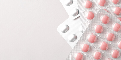 Banner template with heap of pink medical pills and tablets packages and blister packs. Vitamins, painkillers, antibiotics. Copy space for text