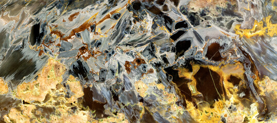 Beautiful decorative stone, natural black, grey and yellow spots and stripes abstract pattern