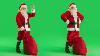 Studio Shot Isolated Mockup Template: Santa Claus with Bag of Gifts For All Good Children On Green Screen Chromakey Background And Waving To Camera. Christmas And New Year