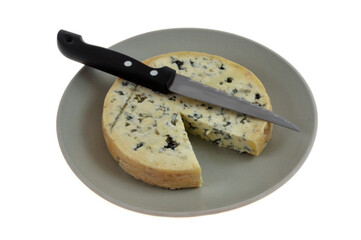 Fromage Fourme d'Ambert dans une assiette avec un couteau en gros plan sur fond blanc